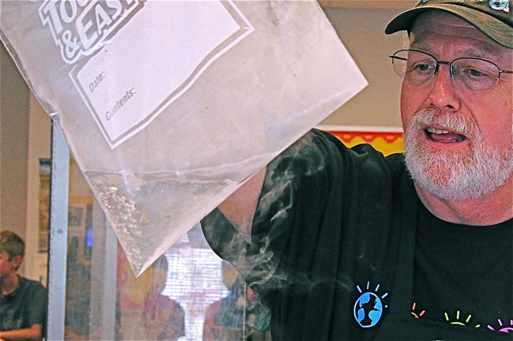 Dr. Kold holding a plastic bag containing liquid nitrogen.